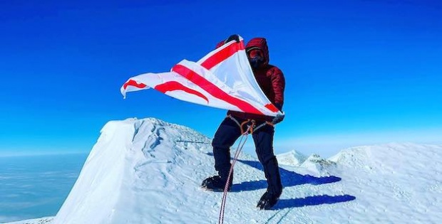 Turkish Cypriot mountaineer waves the flag of TRNC on the summit of Mount Vinson, the highest point in Antarctica