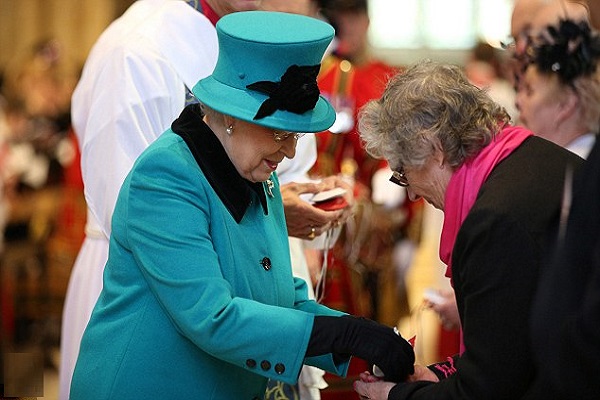 Her Majesty distributes coins during traditional service she first attended as an eight year old princess