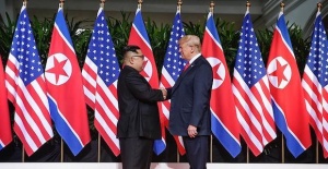 Trump and Kim open historic summit with handshake